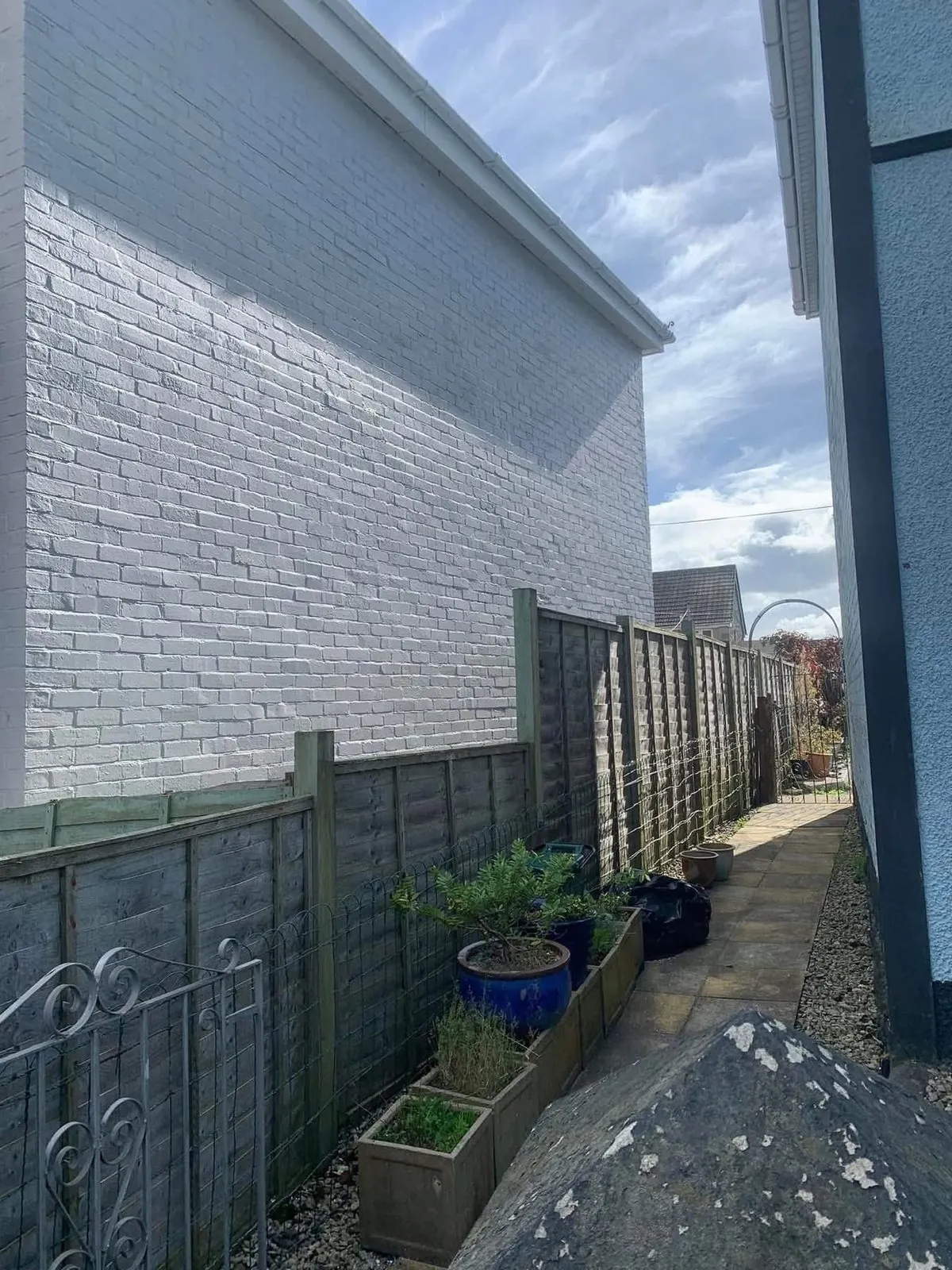 Freshly painted brick wall after preparation and masonry paint in Liskeard